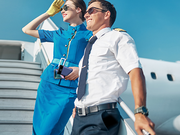 a man and a woman standing on an airplane.