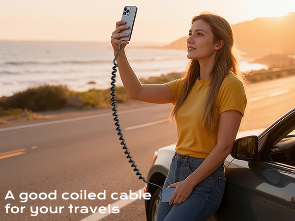 Text reads 'A good coiled cable for your travels'. Outdoor scene at sunset showing a coiled charging cable being held up against golden sky.