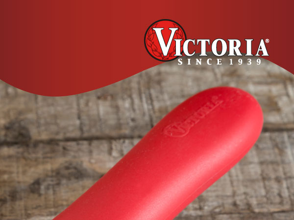 A silicone handle cover for Victoria cast-iron skillets. Text reads: Victoria since 1939.