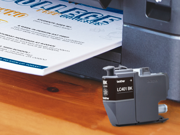 LC401 ink cartridge in front of Brother printer