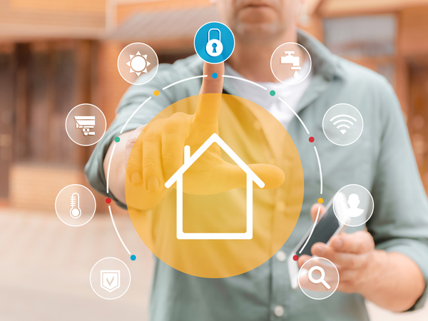 a man pointing at a house with a smart phone in the middle of his finger.