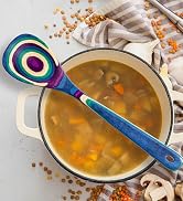 colorful wooden cooking spoon on pot with soup
