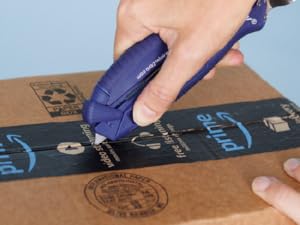Open It Tool slicing through an package