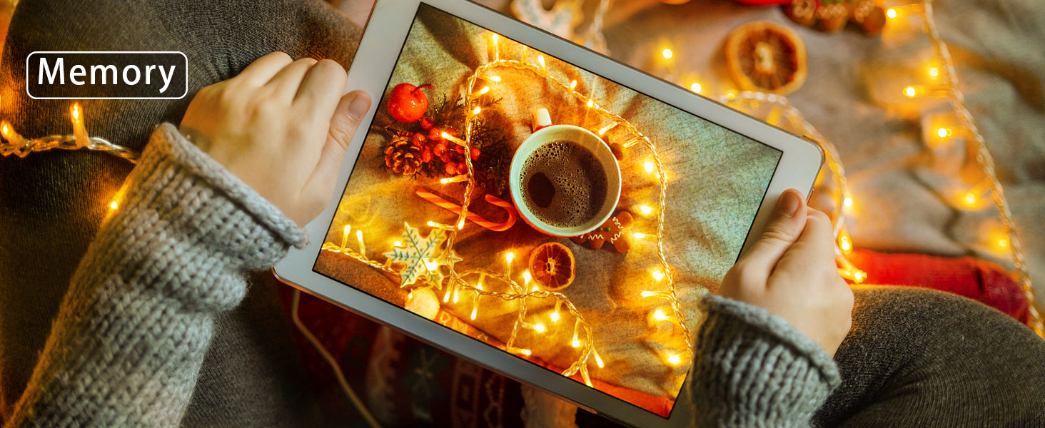 Hands holding a tablet displaying a coffee cup and pastries, surrounded by glowing string lights. Text overlay reads 'Memory'.