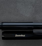 Series of views showing a black metal pen with sleek design. Text reads 'Klous+Urbans'. Multiple angles display the pen's barrel, clip, and tip details.