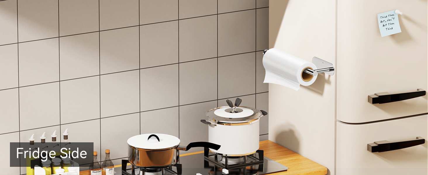 Self adhesive black paper towel holder mounted on refrigerator beside stove for kitchen use