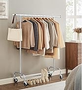 Portable clothing rack with wheels, holding various garments. Features chrome finish, bottom shelf for shoes, and side hook for accessories.