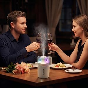 Romantic dinner lit by a humidifier&amp;#39;s warm glow and calming aromatherapy mist