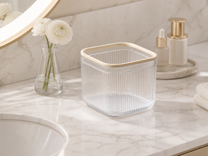 Clear mini trash can on a marble bathroom vanity