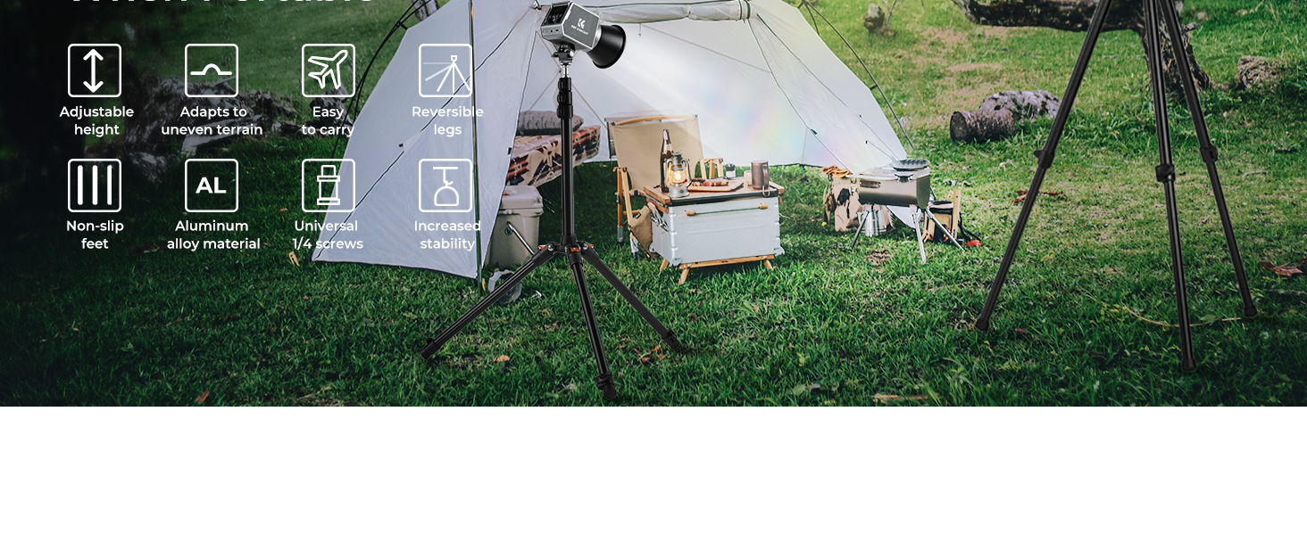 Outdoor photography setup with tripod, camera, and lighting equipment on grass. Background shows wooden crates and furniture, suggesting a rustic themed photoshoot.