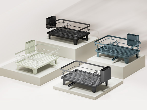 Five mesh desk organizers in various colors (white, teal, black) and designs, displayed in arranged rows against neutral background for size and style comparison.