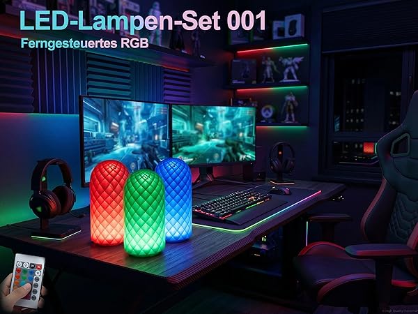 Text reads "LED-Lampen-Set 001" and "Ferngesteuertes RGB". Two glowing RGB LED cylindrical lamps in red and green on desk with gaming setup, monitors, and controller visible.