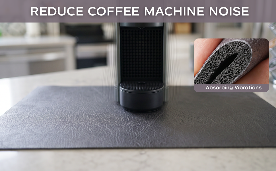 Espresso machine on a dark gray cushioned coffee mat that absorbs vibrations and reduces noise.