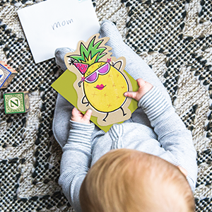 Baby holding a fun card