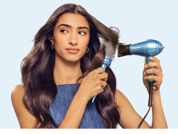 Woman using hair dryer