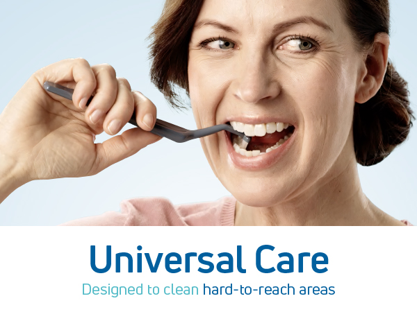 A woman using a small soft toothbrush.