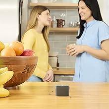 Image of home owners talking in the kitchen with the fly trap on the kitchen counter