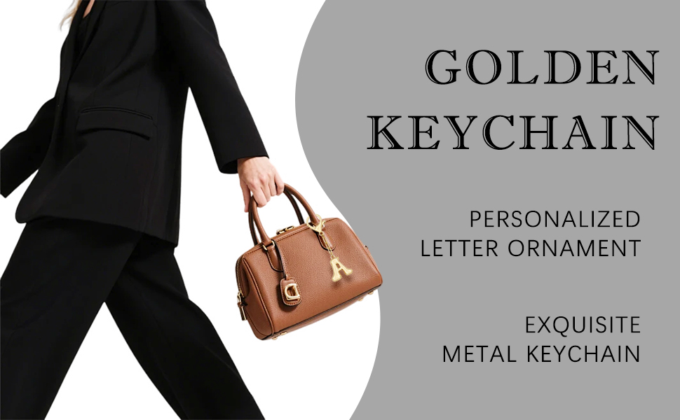 Woman in black suit with brown handbag & golden letter A keychain, elevating everyday style.