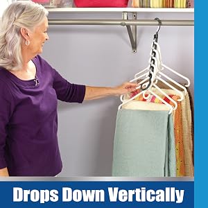 Silver haired senior lady in purple shirt hanging table runners and linens on the Wonder Hanger Max.