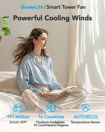 Smart tower fan with powerful cooling winds, featuring 14 comfort modes and auto temperature sensor. Woman sitting cross-legged near window, experiencing airflow.