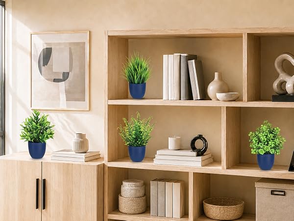four artificial green plants blue pots bookshelf decor