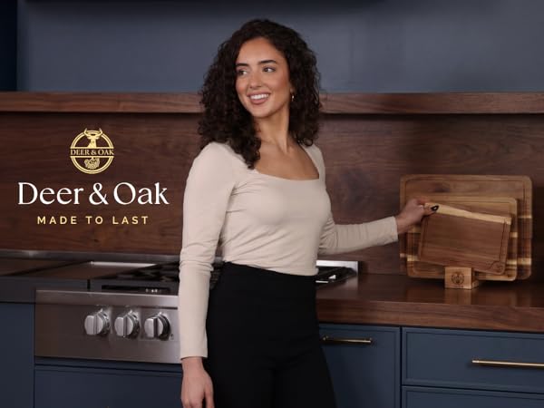 Woman holding wooden cutting boards in modern kitchen.