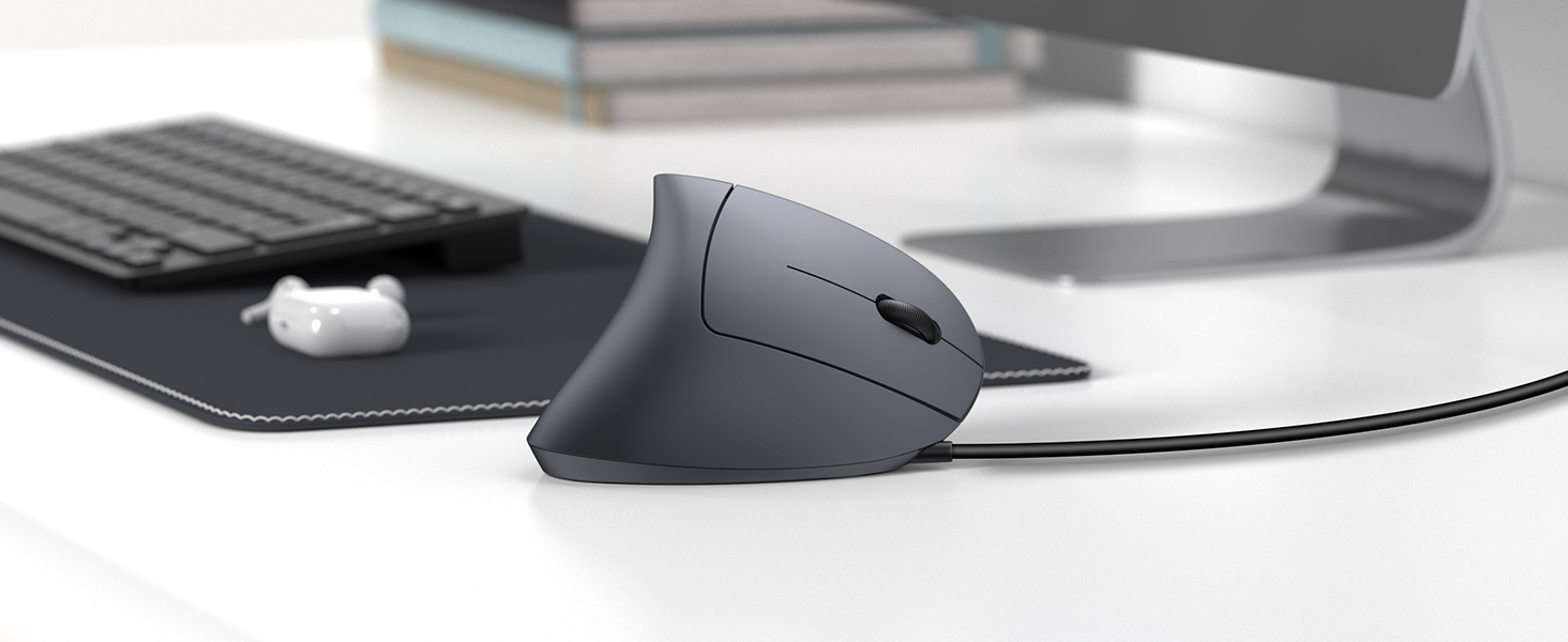 Ergonomic vertical computer mouse in black, featuring a unique upright design positioned next to a mousepad.