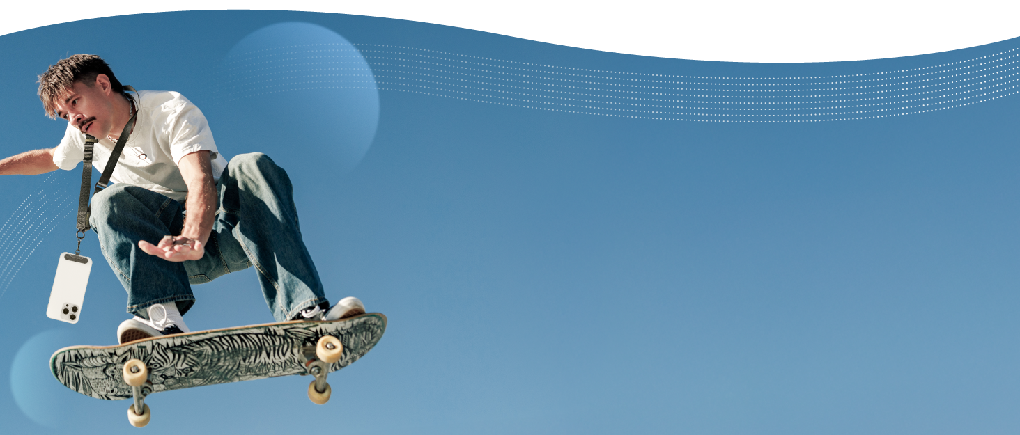 A person performing a skateboarding trick, midair against a blue sky. The skateboard has a visible design on its underside.