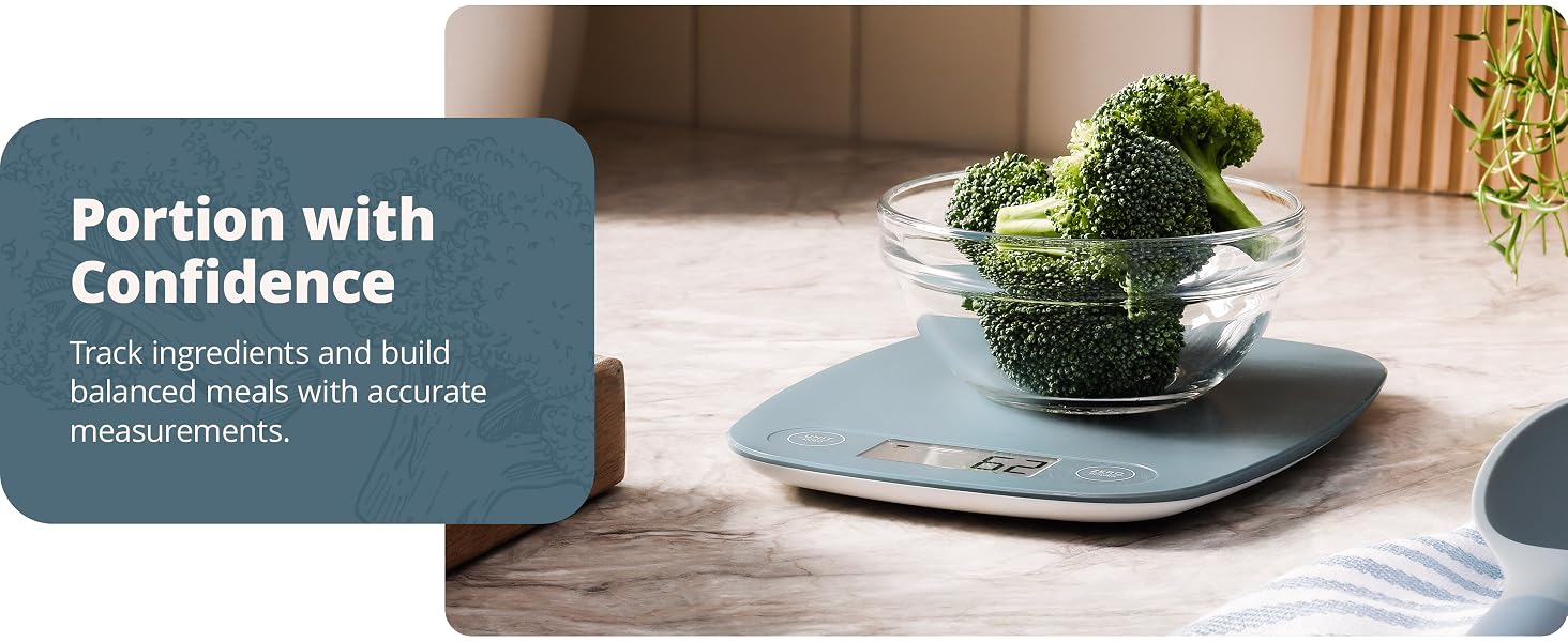 greater goods stone blue kitchen scale on marble countertop weighing bowl of broccoli