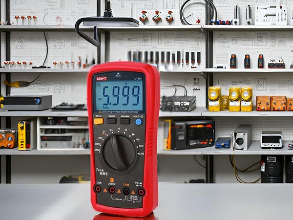 A close-up view of the product on a workbench surrounded by various electrical components and tools.