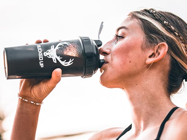 Woman drinking from Bucked Up Perfect Shaker bottle