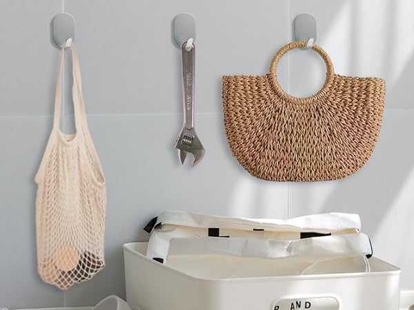 Collection of light-colored storage and organization items including mesh bags, woven baskets, and hanging organizers against white background.