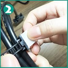 Close-up of a hand using a small white tool to adjust or clean a black mechanical component, possibly part of a bicycle or other equipment.