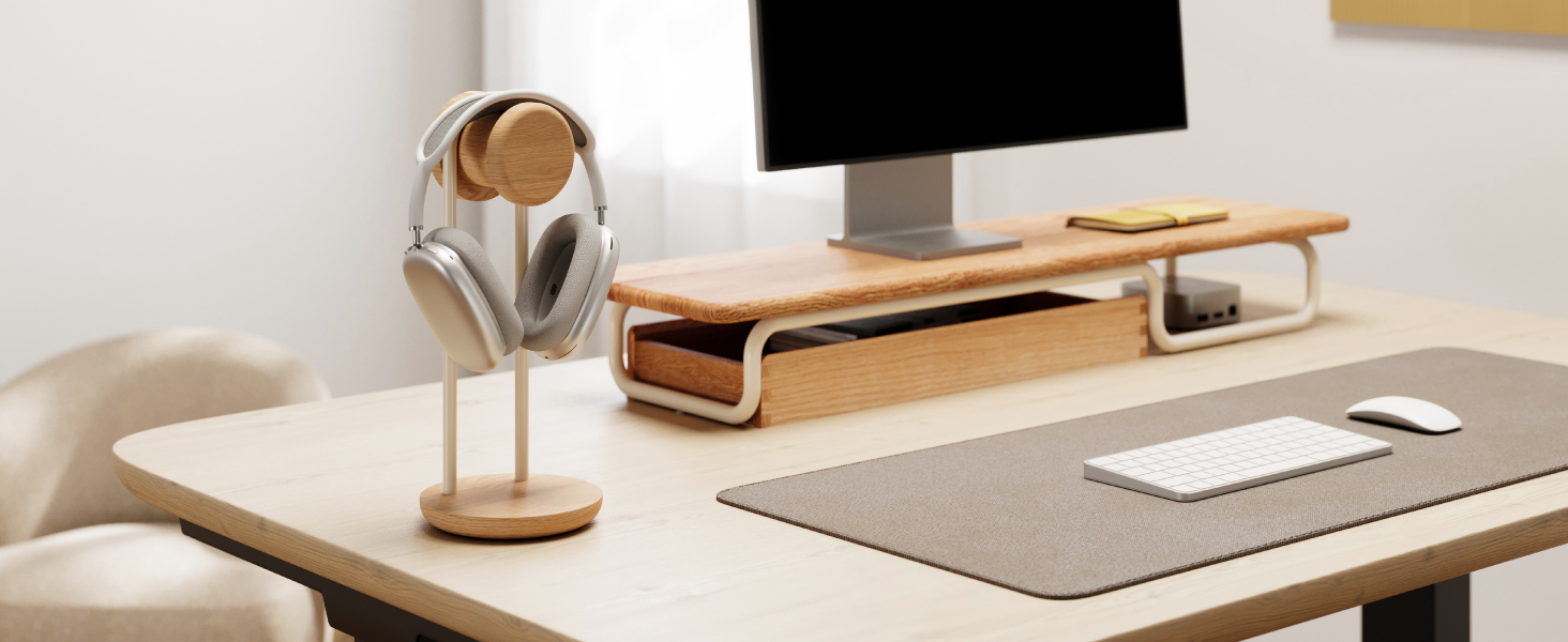 Modern desk workspace setup featuring wooden desk accessories, mousepad, and electronic devices in a clean, minimalist arrangement.