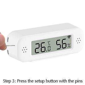 Small white digital device with LCD display showing temperature and humidity. Setup button visible on side.