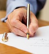 Silver and gold Scriveiner pen writing on a page