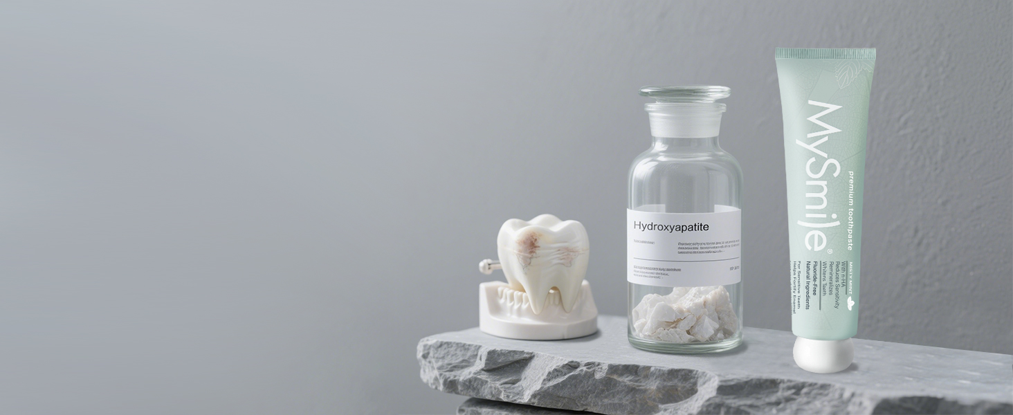 Collection of white skincare or beauty products arranged on light gray background, featuring bottles, jars, and tubes with minimal aesthetic.