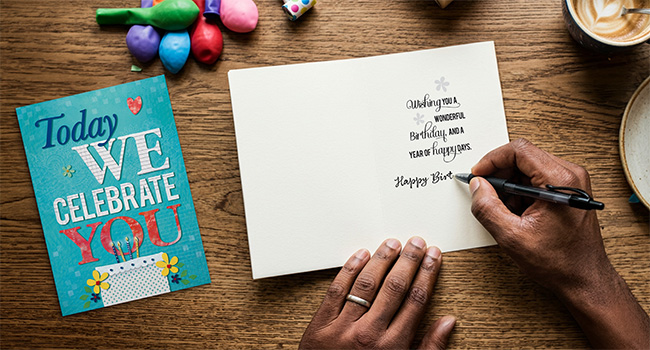 Handwriting on birthday card on tabletop