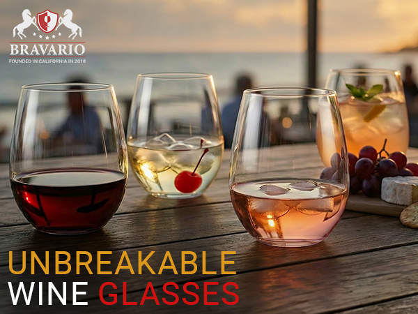 Red and white wine in unbreakable stemless wine glasses on a patio table.