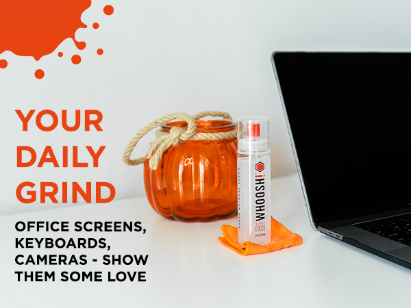 WHOOSH! screen cleaner bottle and microfiber cloth next to a MacBook Pro laptop.