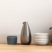 Lifestyle image of the flying insect trap placed with other kitchen items on the counter