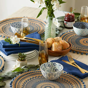 An image of a beautifully placed table, complete with DII rounded braided placemats