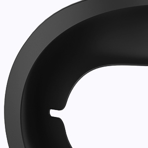 Close-up of a black, curved object with a smooth surface and a notched section, possibly part of a larger product or device.