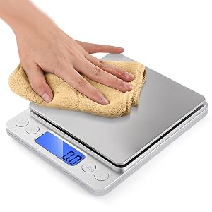 hand wiping a weight scale