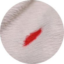 Close up of blood on white fabric.