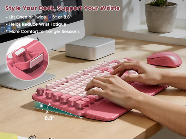 Pink retro keyboard and mouse with adjustable tilt legs for comfortable typing.