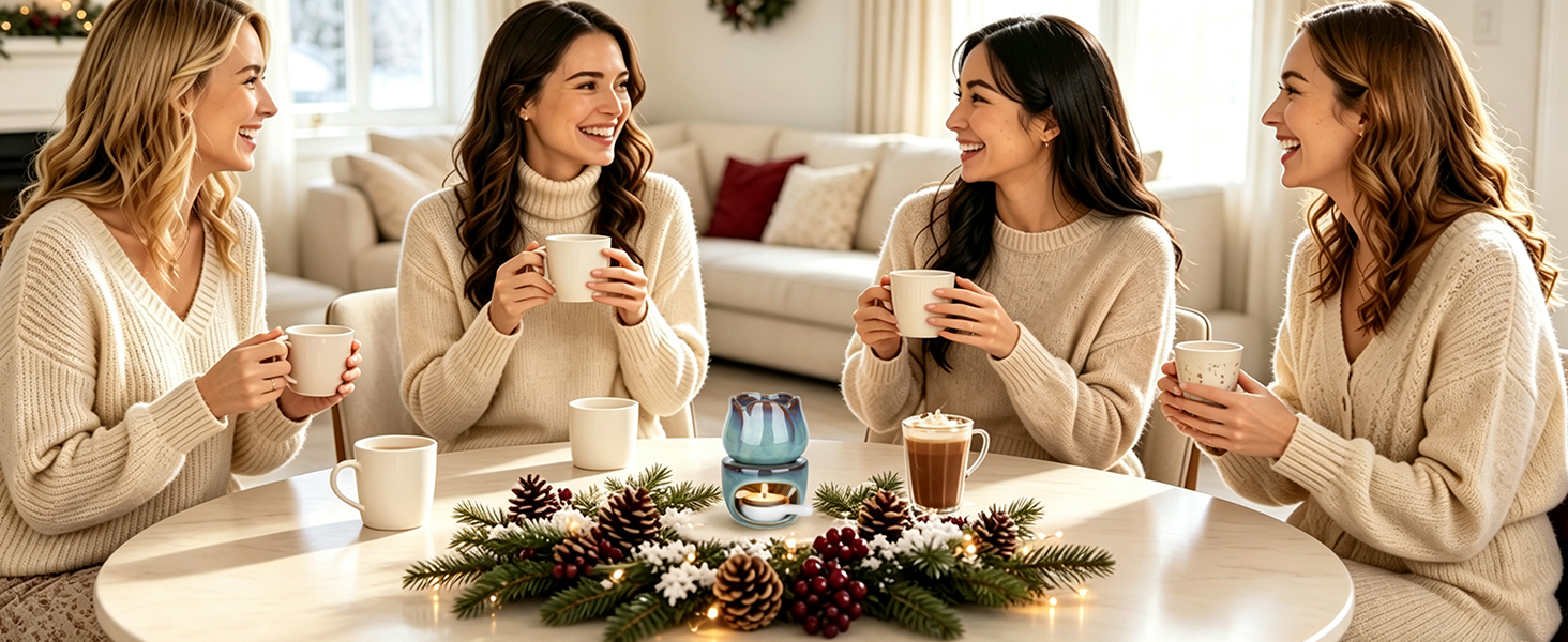 Four women seated around dining table with festive centerpiece and place settings, engaged in conversation while holding cups in home interior setting.