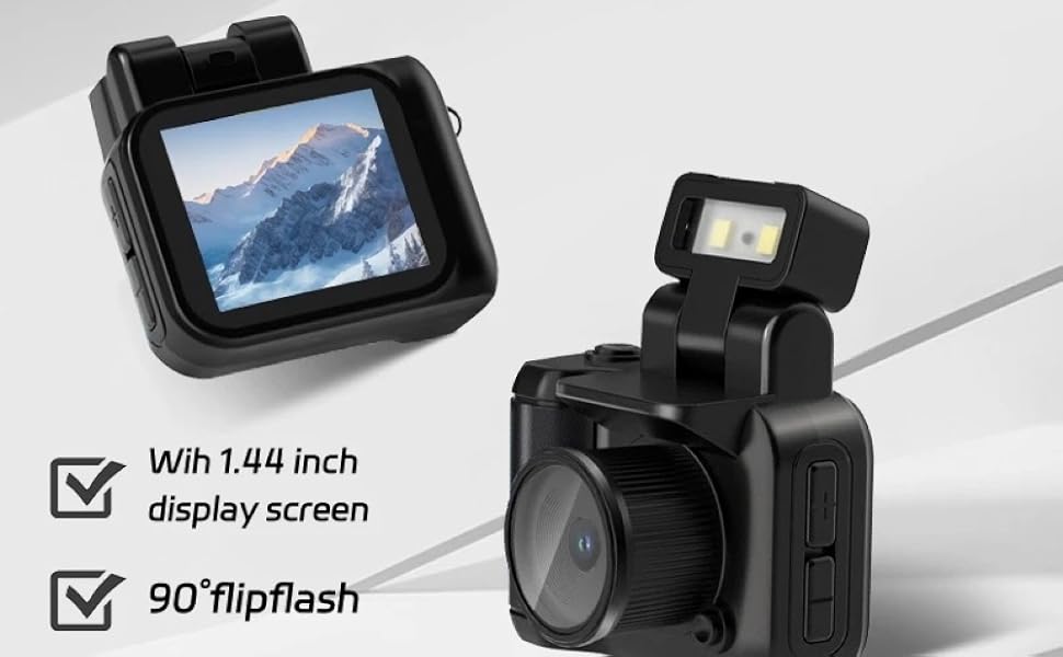 Black digital camera with 1.44 inch display screen, 90° flip flash, and multiple filters. Screen shows mountain scene. Camera features compact design with adjustable flash.