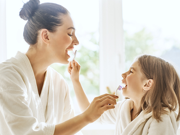 family brushing teeth