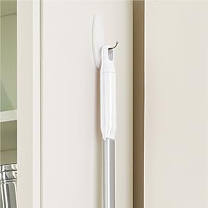 Save even more space by using the handle loop to hang the sweeper up on the wall.